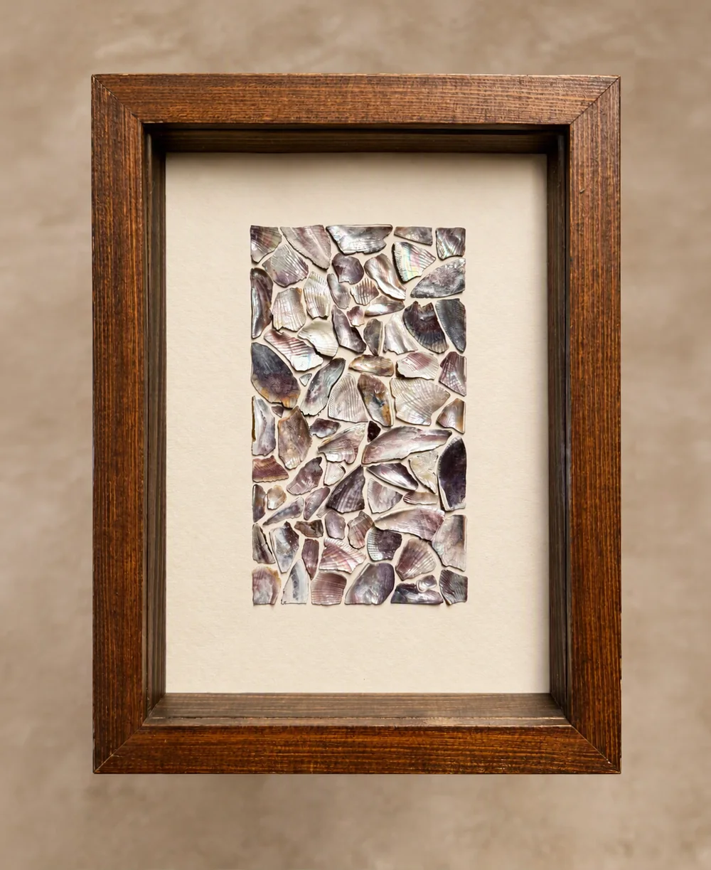 Framed mosaic made from carefully arranged iridescent shell fragments